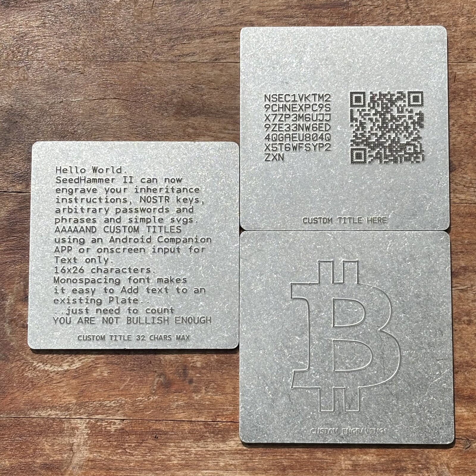 Four metal plates engraved on a SeedHammer II: a 16x26 block-text plate with a custom title, a Nostr nsec plate with QR code, and a plate carrying an SVG-engraved Bitcoin symbol with its own custom title.